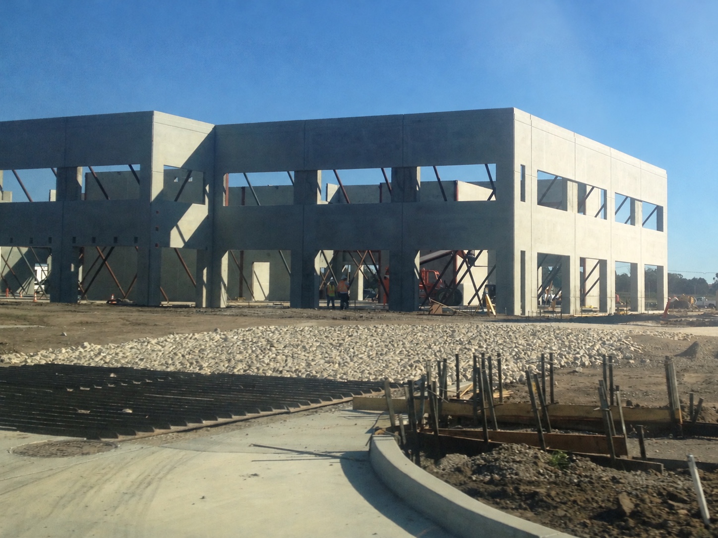 Two-story tilt-up concrete shell with a telehandler in Goleta, California