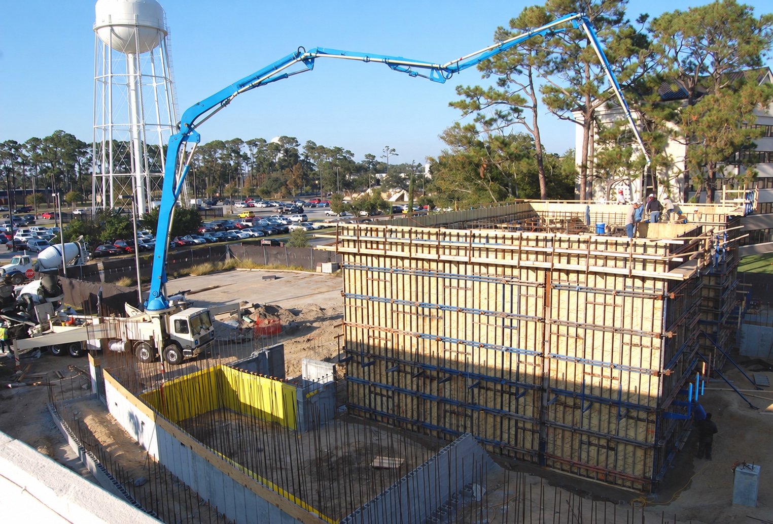 Boom pump placing concrete in the walls of a low-rise medical building at Keesler, Mississippi