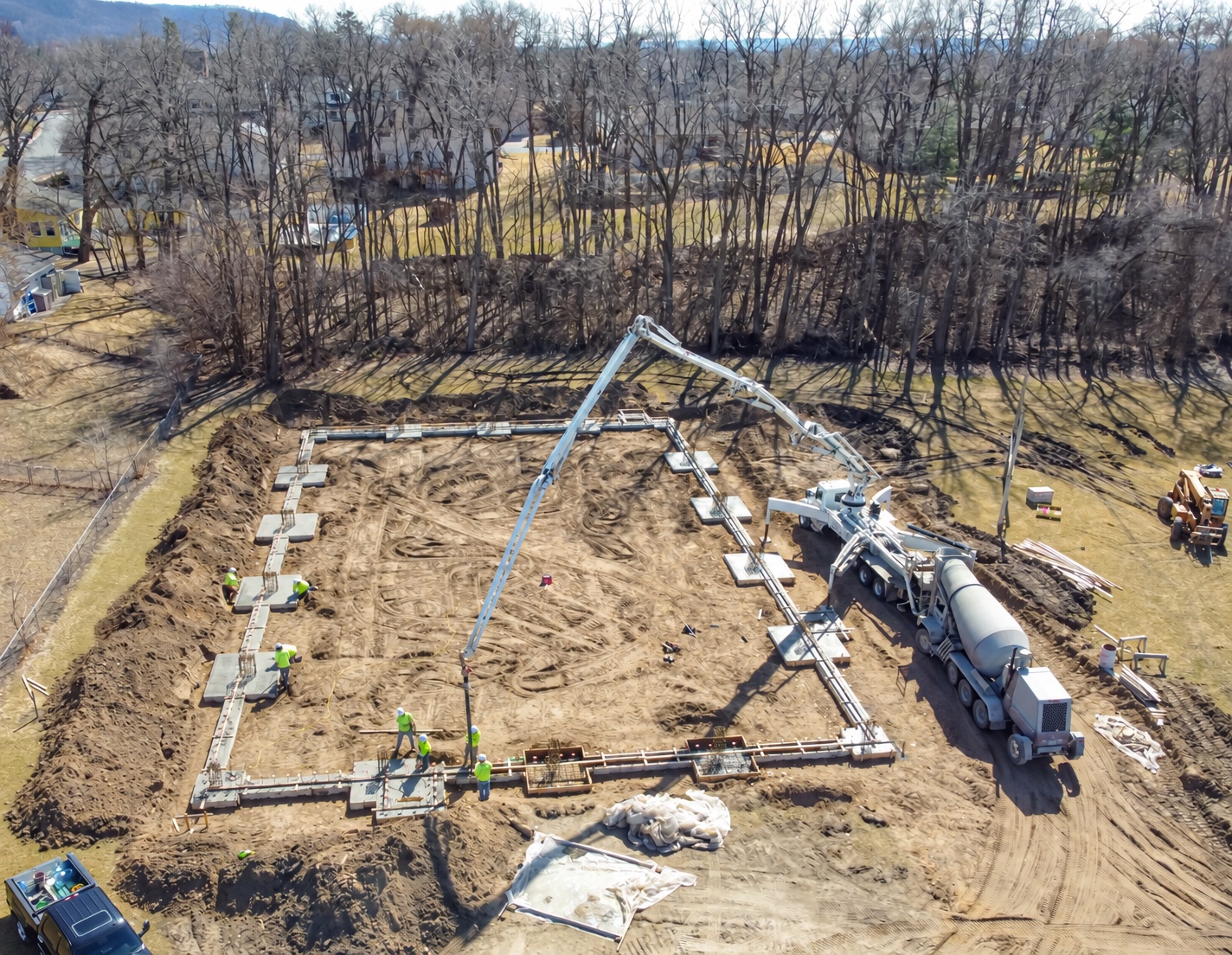 Overhead view of concrete foundations with a boom pump, mixer and telehandler in Onalaska, Wisconsin